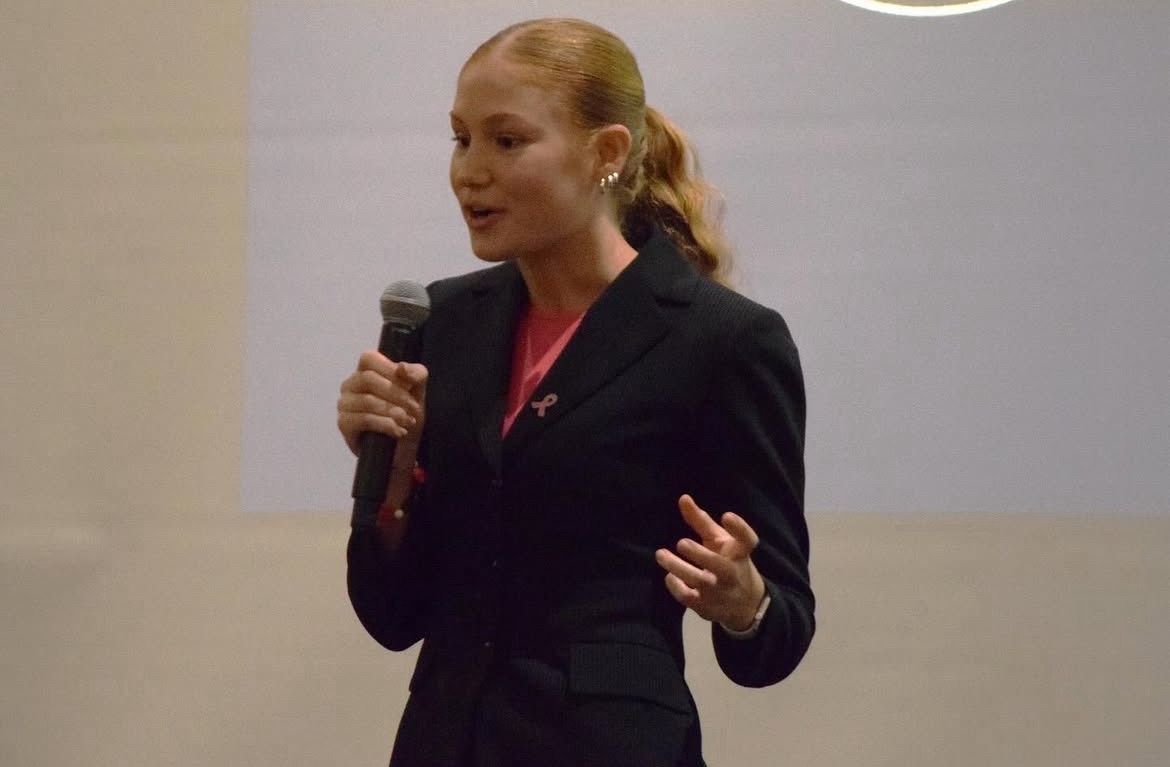 Julie presenting Revion with a microphone.