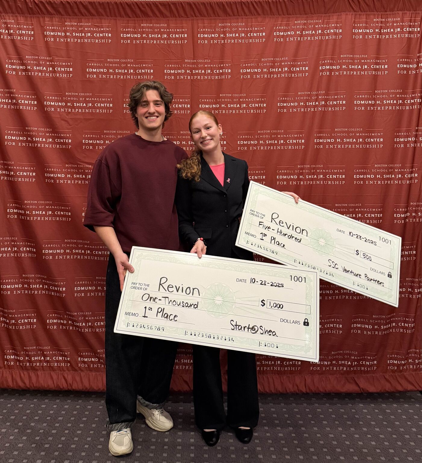 Julie and a Revion teammate holding first-place competition checks.